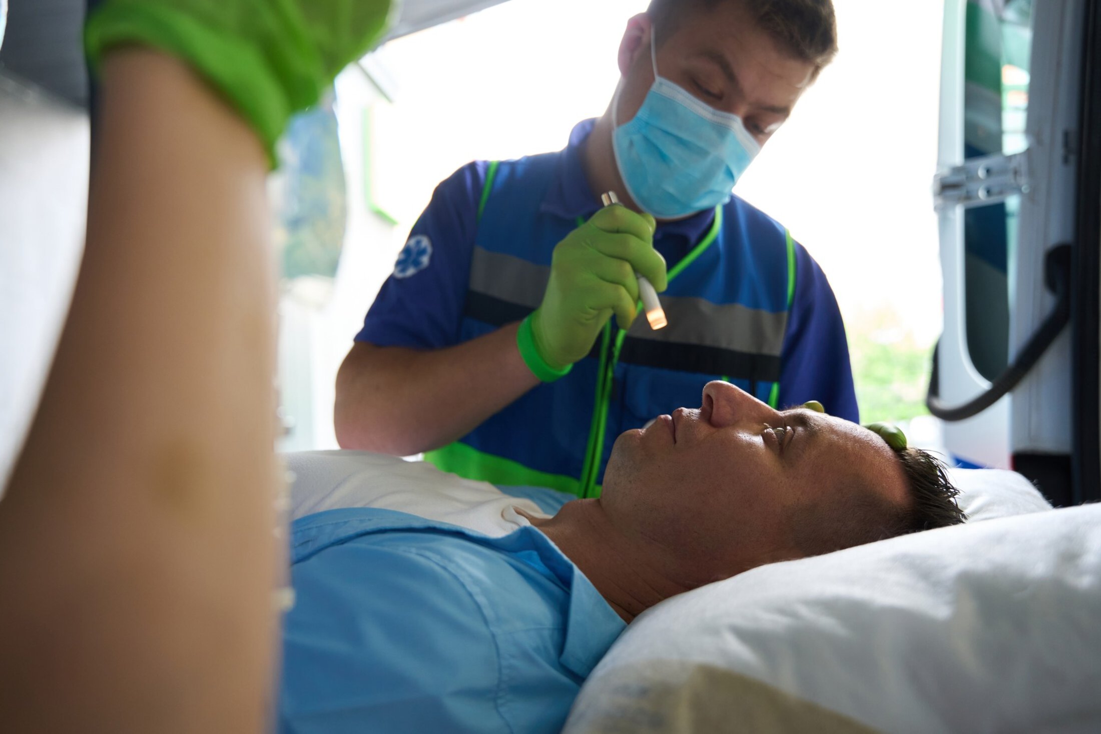 Doctor in the ambulance assesses condition of victim in accident