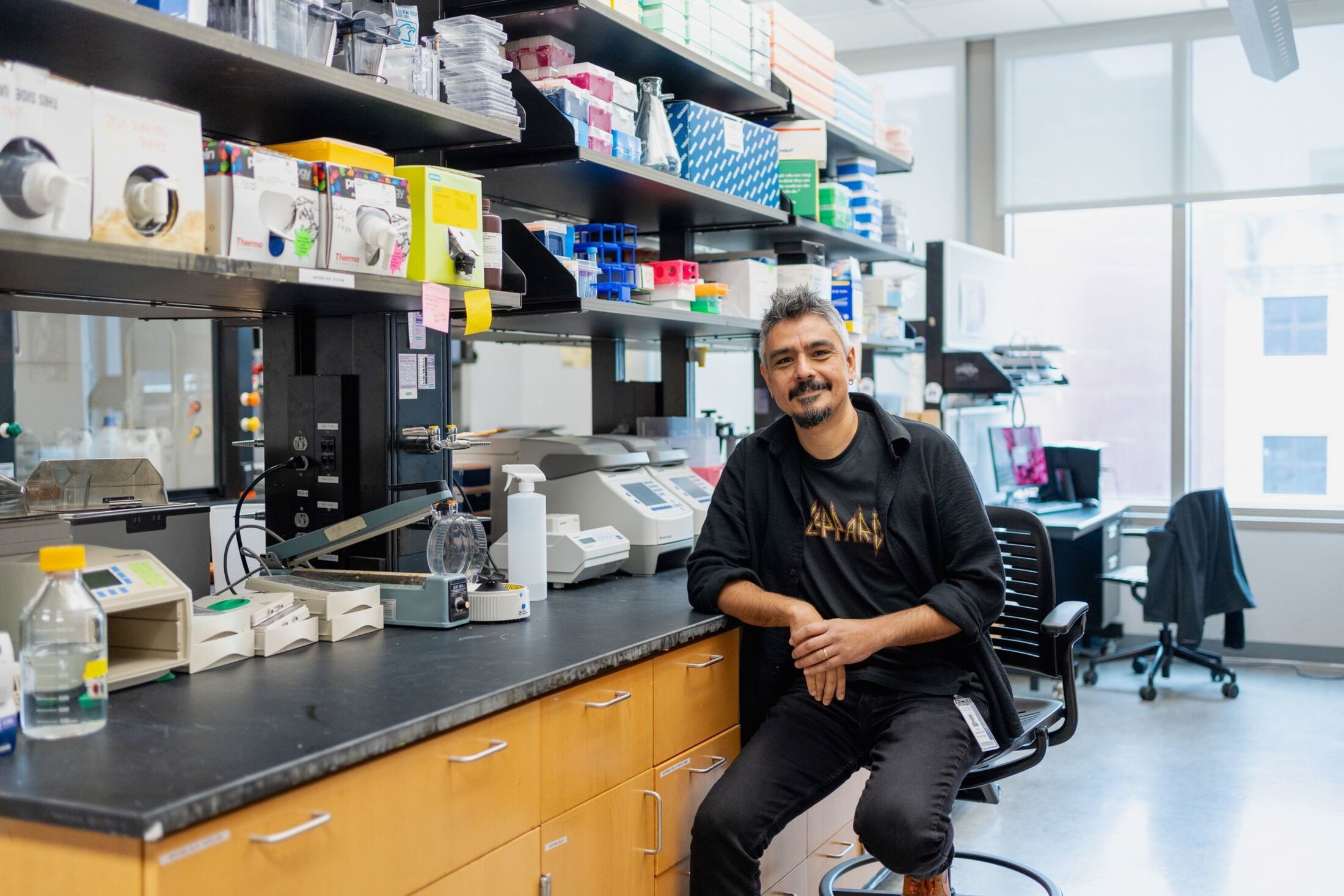 Dr. Onder Albayram is sitting in his lab smiling at the camera.