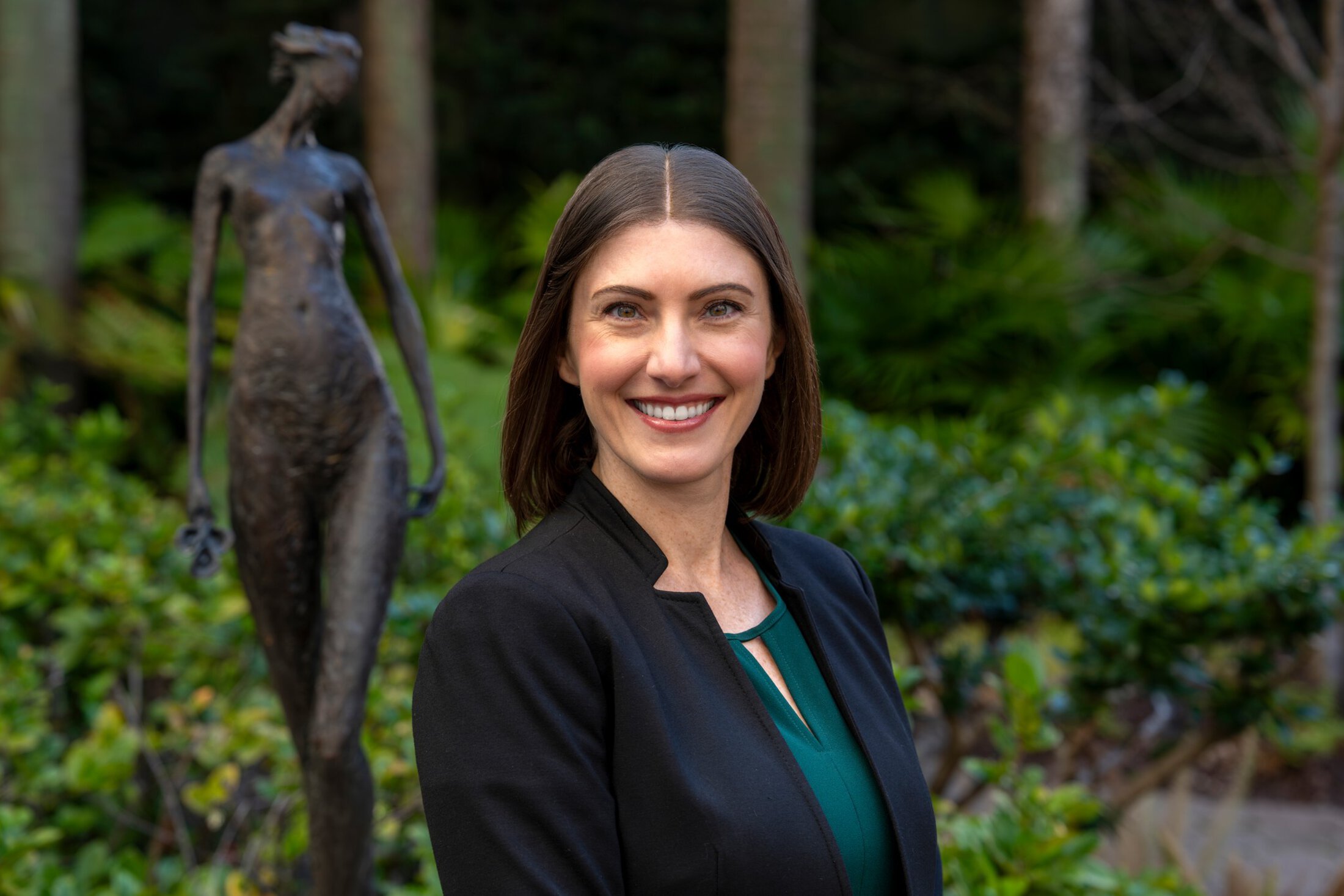 Alana Rojewski in business attire in the garden.