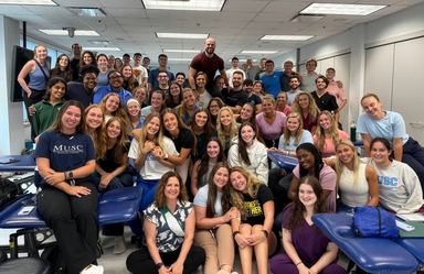 A large group of male and female students gathered in a posed shot.