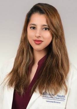 Anshika Singh MD wearing a white coat
