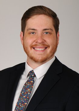 Timothy Webb wearing a suite dress shirt and colorful tie