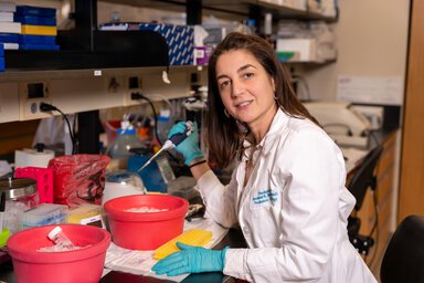Jezabel Rodriguez Blanco pauses in her work in her lab.