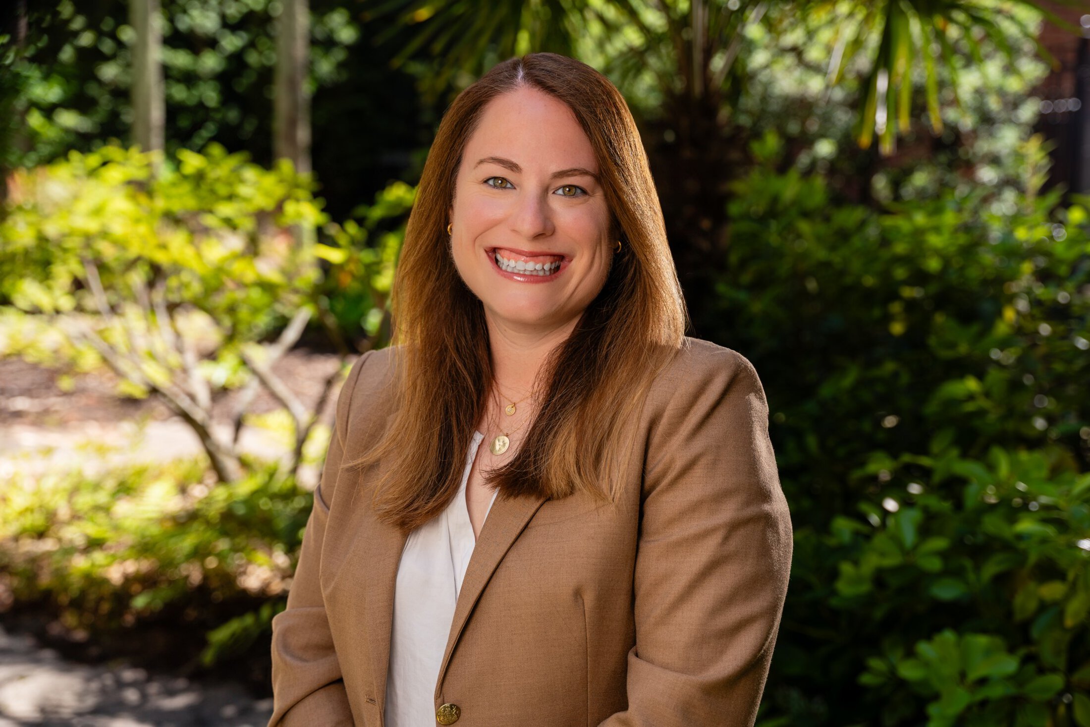 Jennifer Dahne headshot in a garden setting