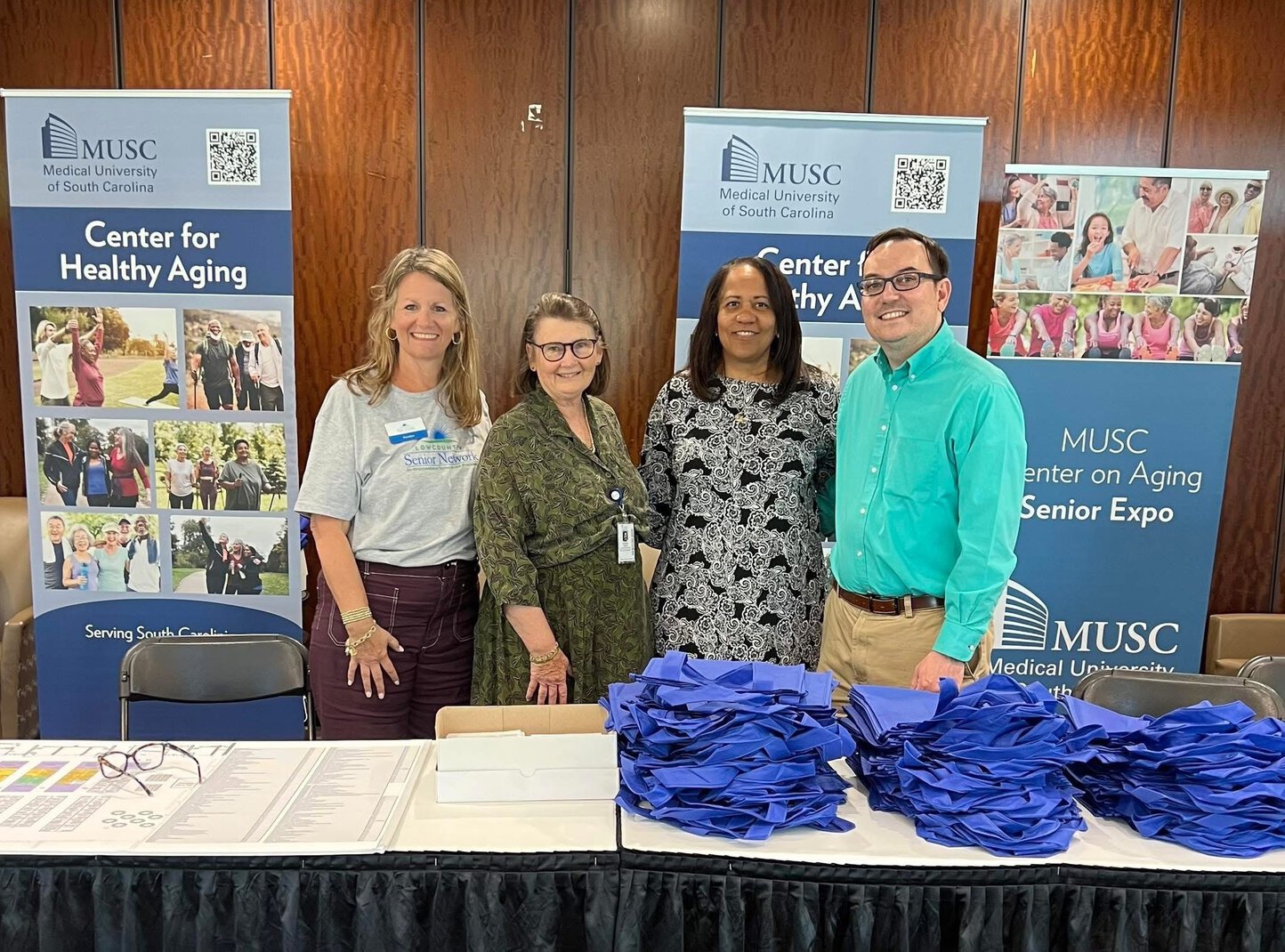 Mary Rohaley, Caroline Davila, Stephanie Blunt and Michael Christopher setting up for the March 2025 Senior Expo