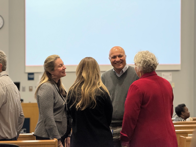 Group of people talking at an event.