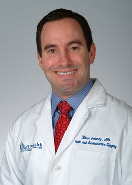 Kevin Delaney, MD, Cancer - Breast,Cancer - Melanoma & Skin,Plastic & Reconstructive Surgery,Breast Surgery wearing a white coat