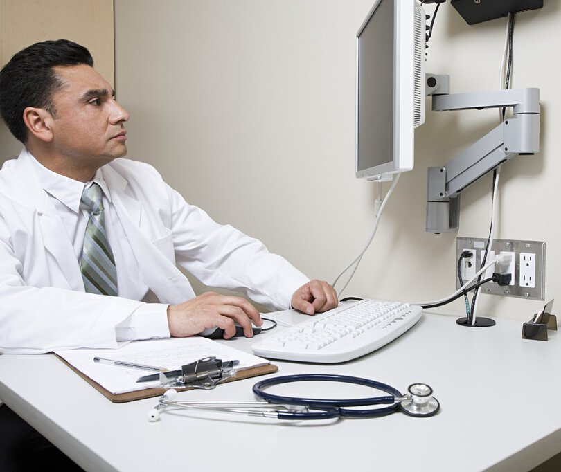 Doctor looking at computer screen
