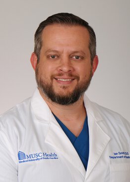 Ian Smith, DO, Assistant Professor wearing a white coat
