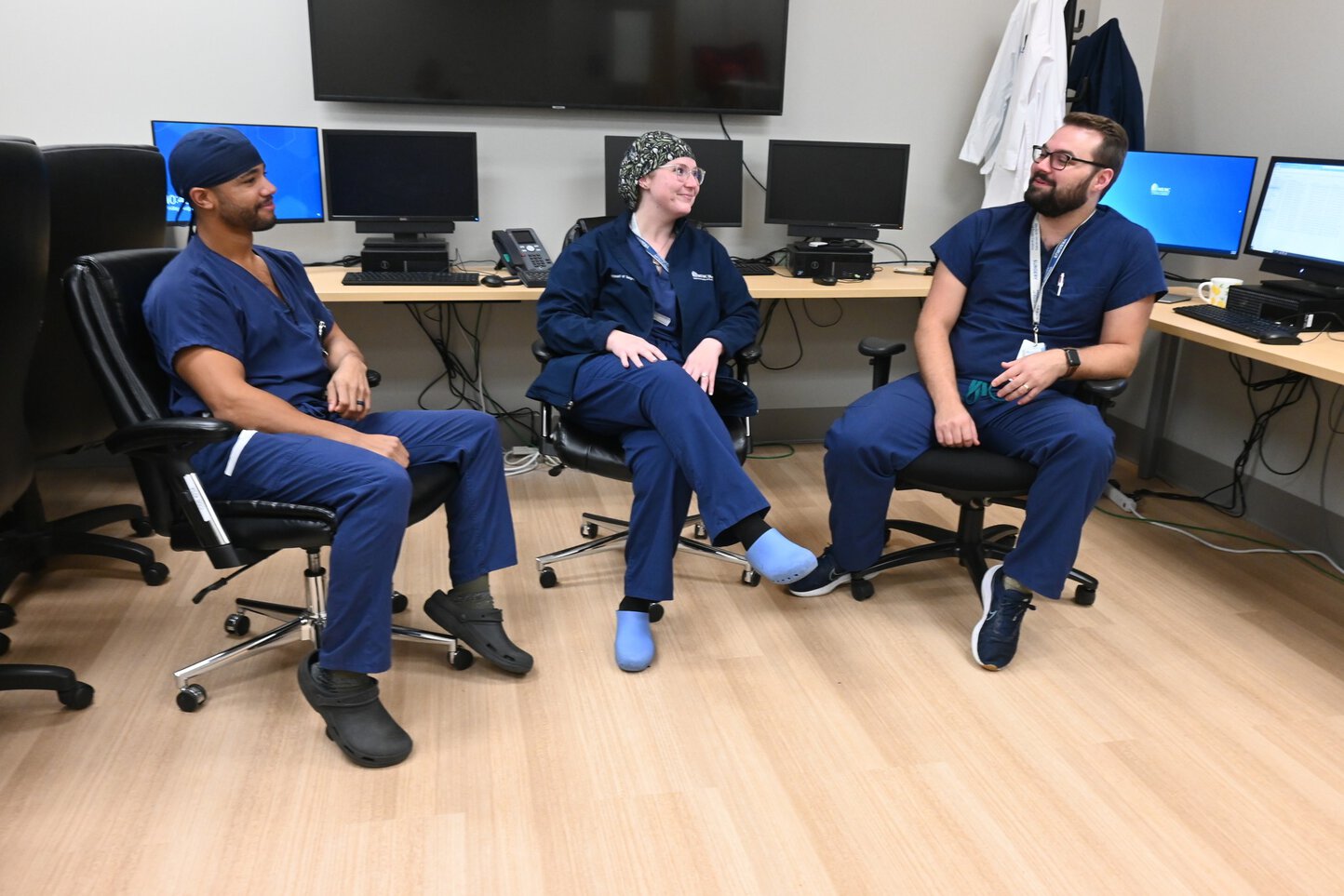 General Surgery Residents Daniel Akyeampong, M.D. MD, Mallorie Huff, MD, and Andrew Wortham MD in their resident workspace