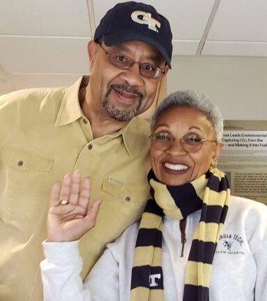 Patient and his wife stand together.