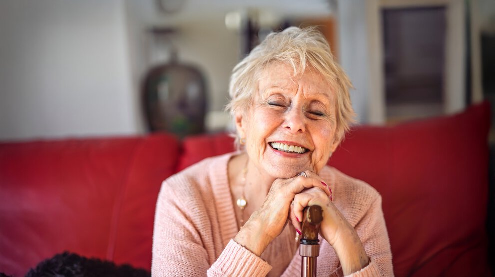 A Beautiful senior woman sit on sofa with canes at home