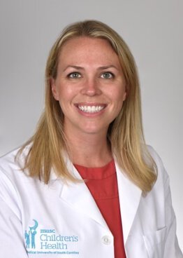 Elise Zivick Pediatrics wearing a white coat