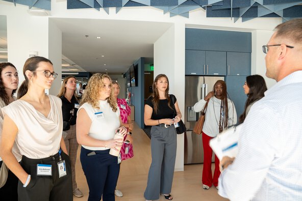 A man speaks to a group of adult females.
