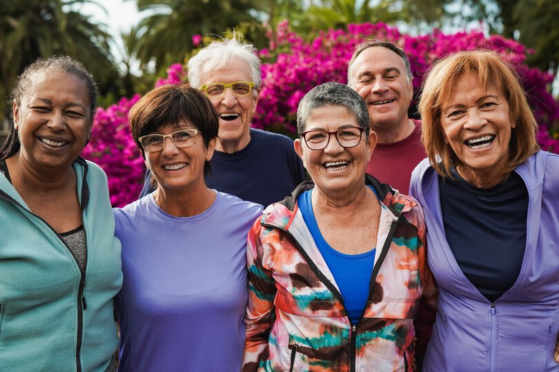 Multiracial senior friends smiling on camera after yoga lesson at city park