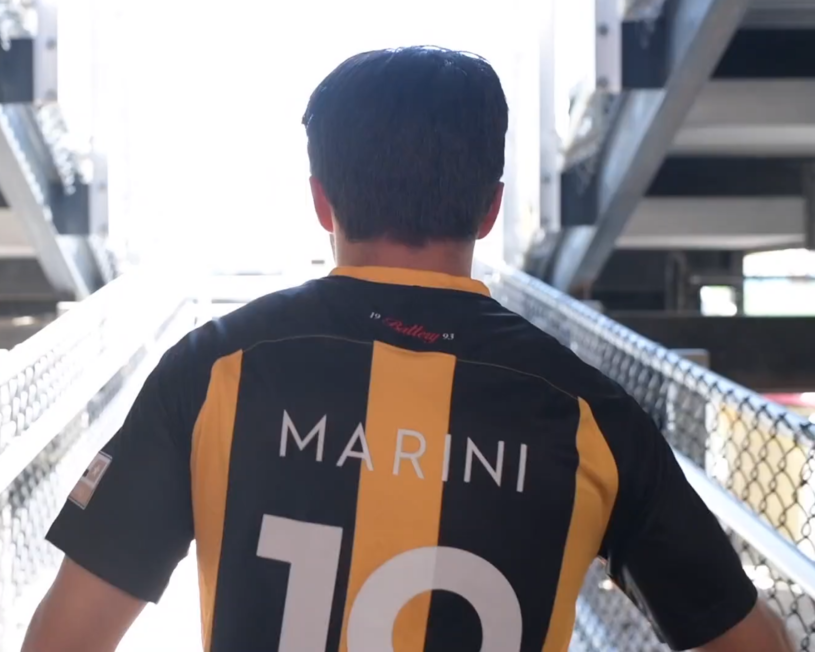 person wearing jersey walking into arena