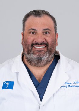 John Kenna wearing a white coat