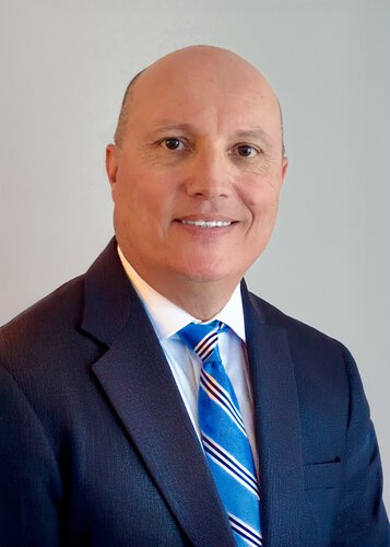 Peter Hull CCMO, wearing a suit and tie