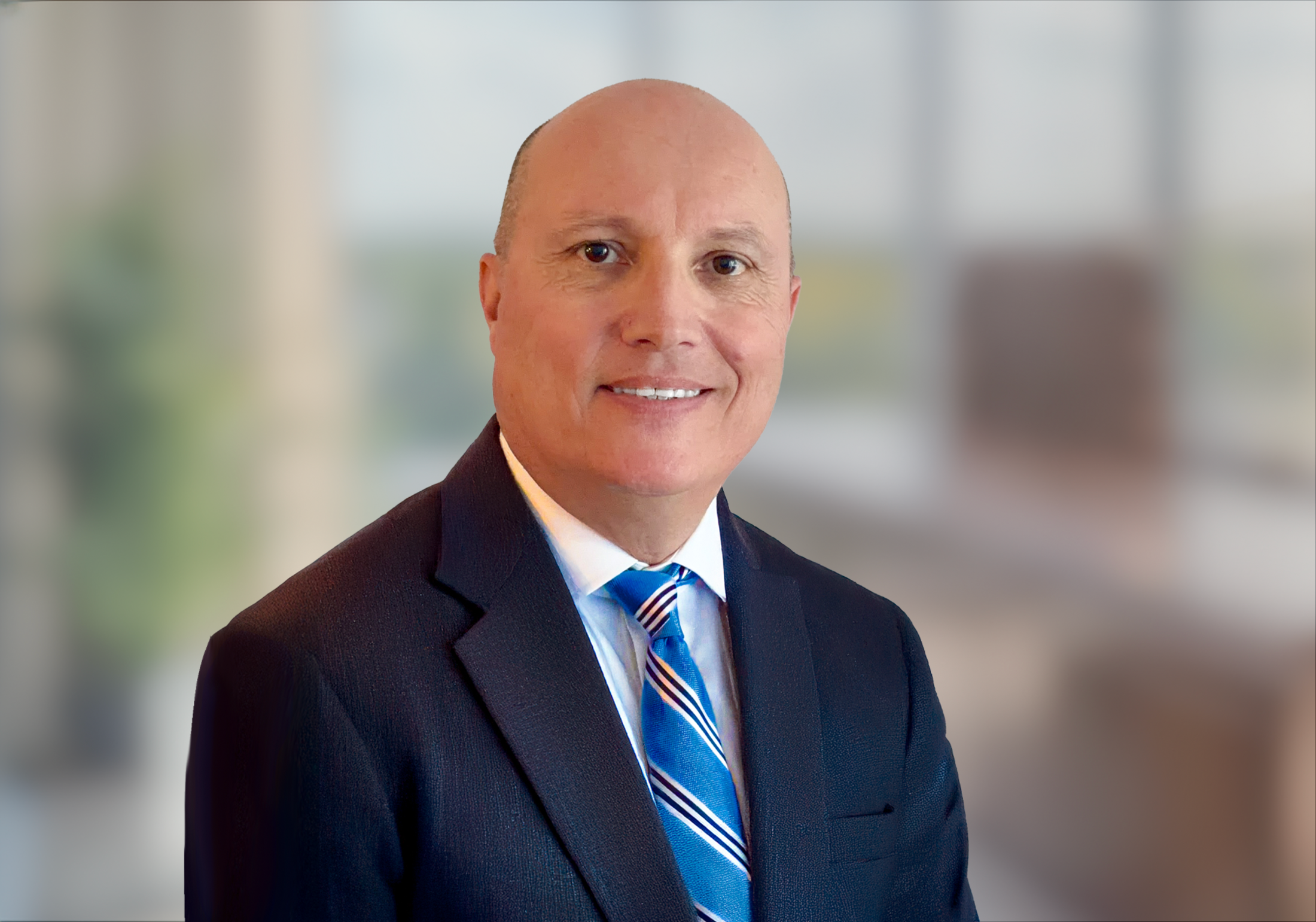 Peter Hull CCMO, wearing a suit and tie