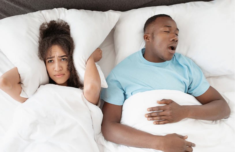 Snoring man sleeping with apnea and sleepless woman, angry wife unable to sleep.