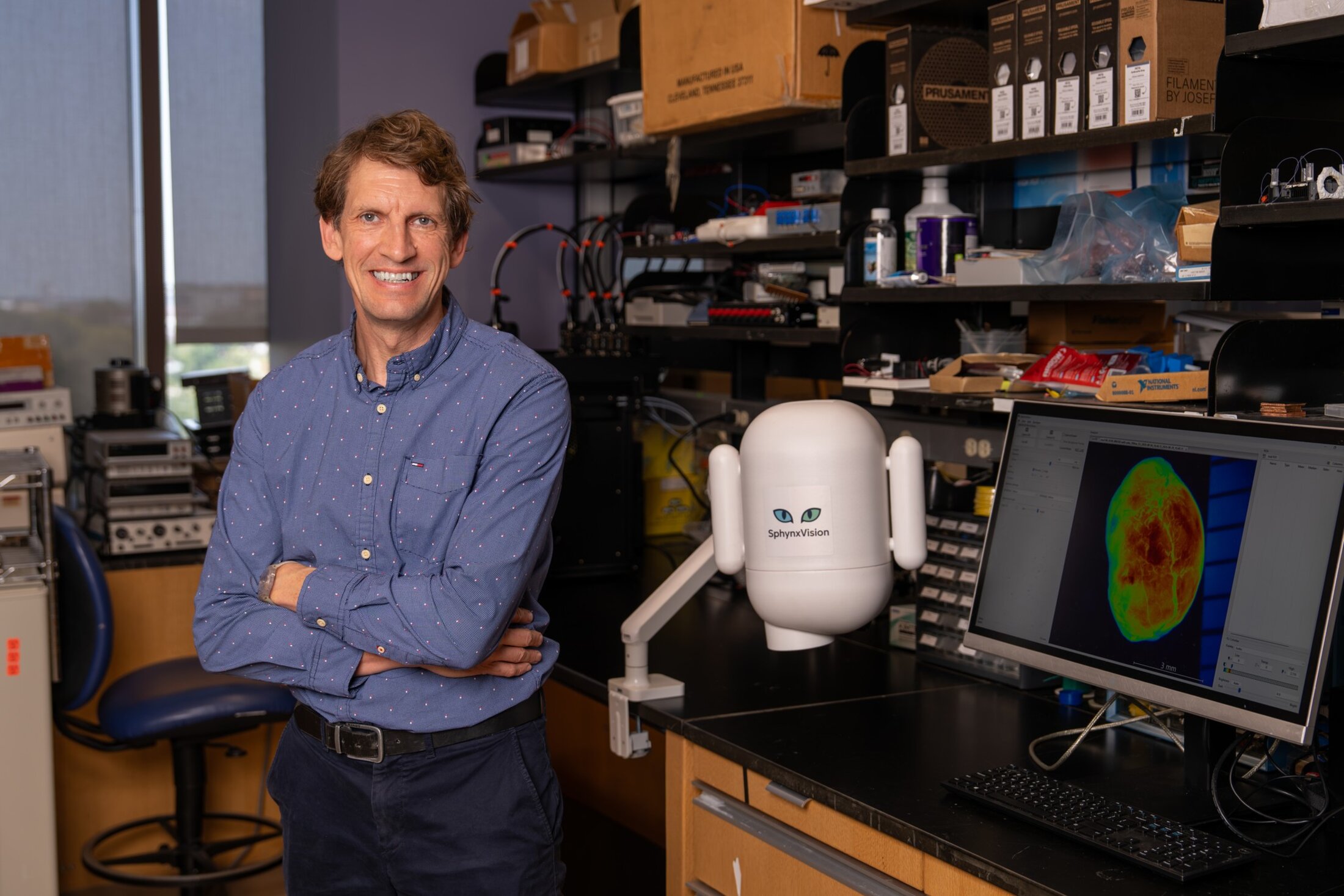 Dr. Dieter Haemmerich poses in a lab with his SphynxVision device.