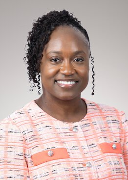 Shametra Myers RN MSN CCRN Executive Director wearing a peach sweater