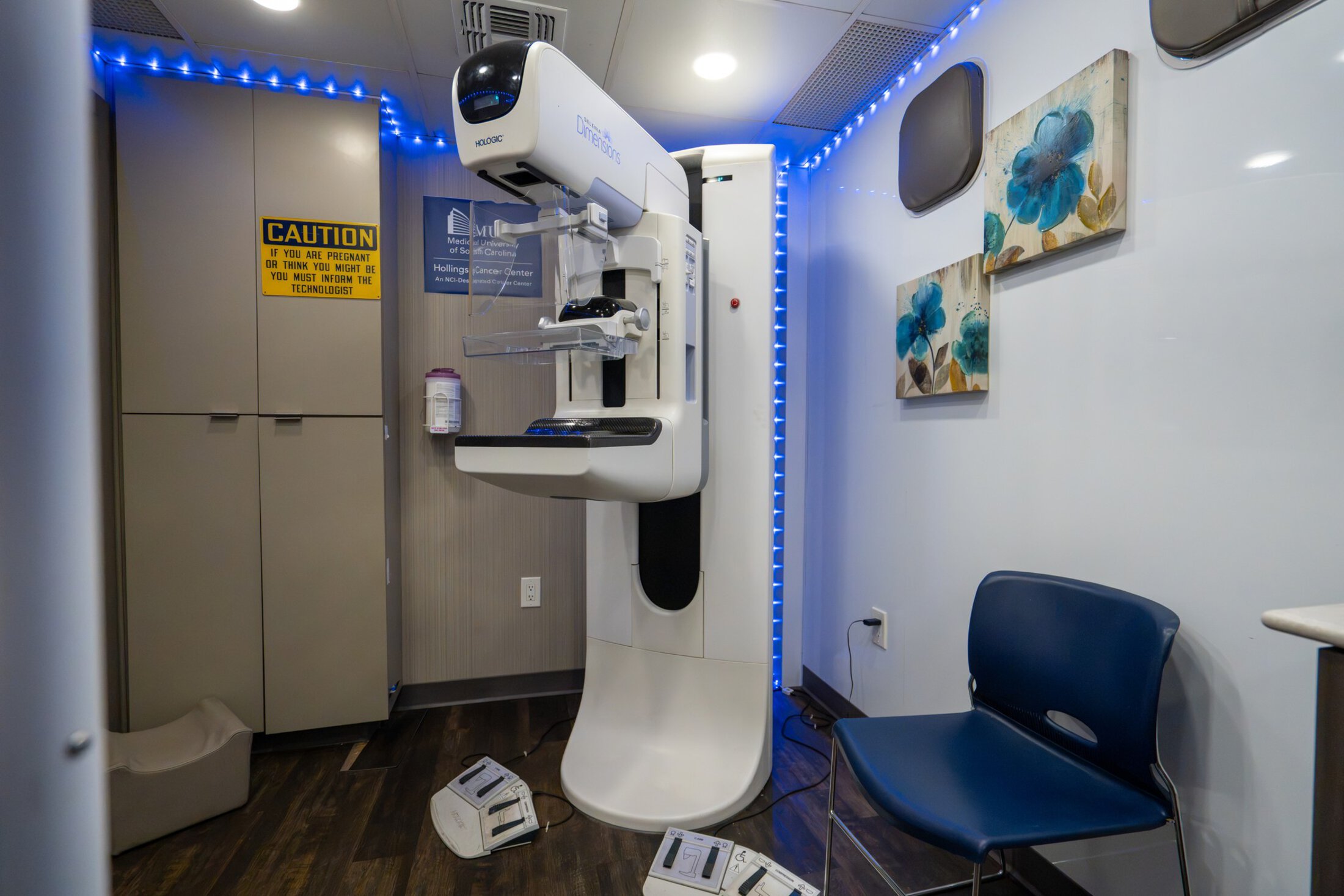 A mammography scanning machine stands ready for a patient.