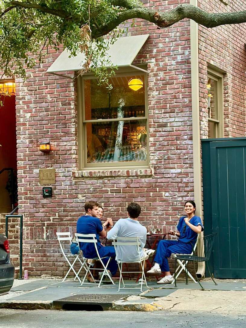 Picture of 4 residents in scrubs at a Charleston coffee shop