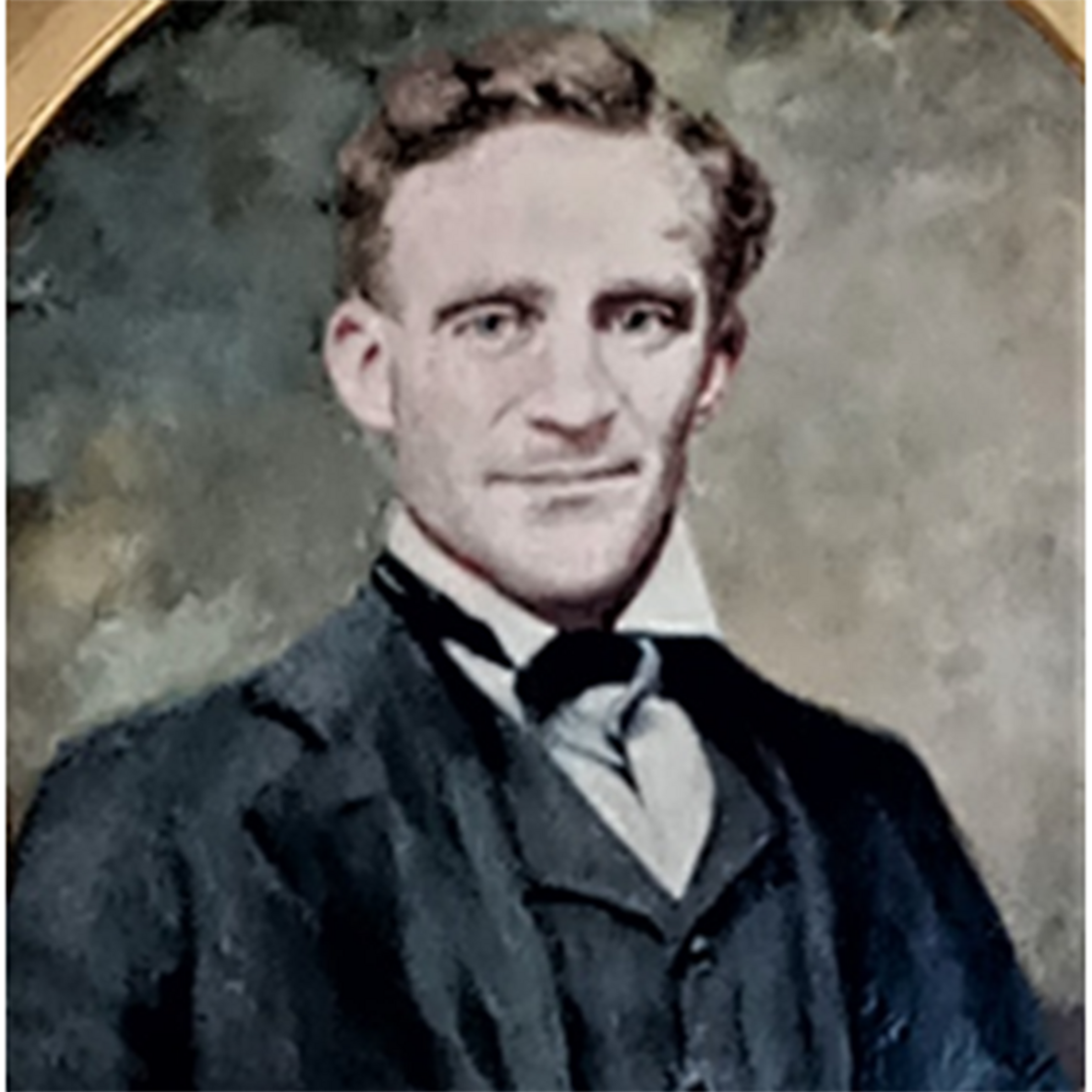 Old photo of a man wearing a black suit. Hehas brown hair.