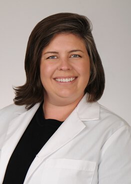 Assistant Professor, Pediatric Critical Care Medicine wearing a white coat