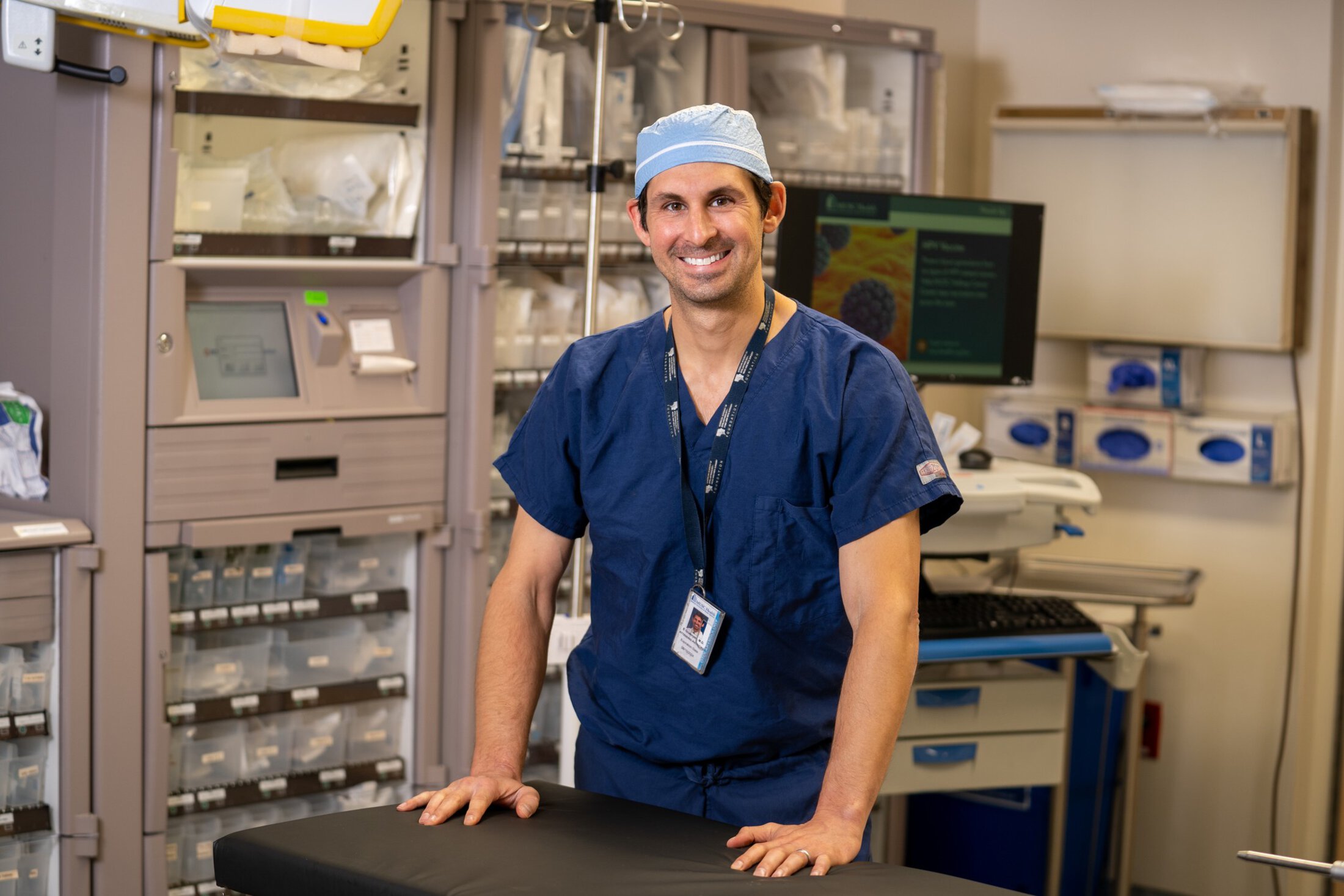 A surgeon poses in an empty operating room.