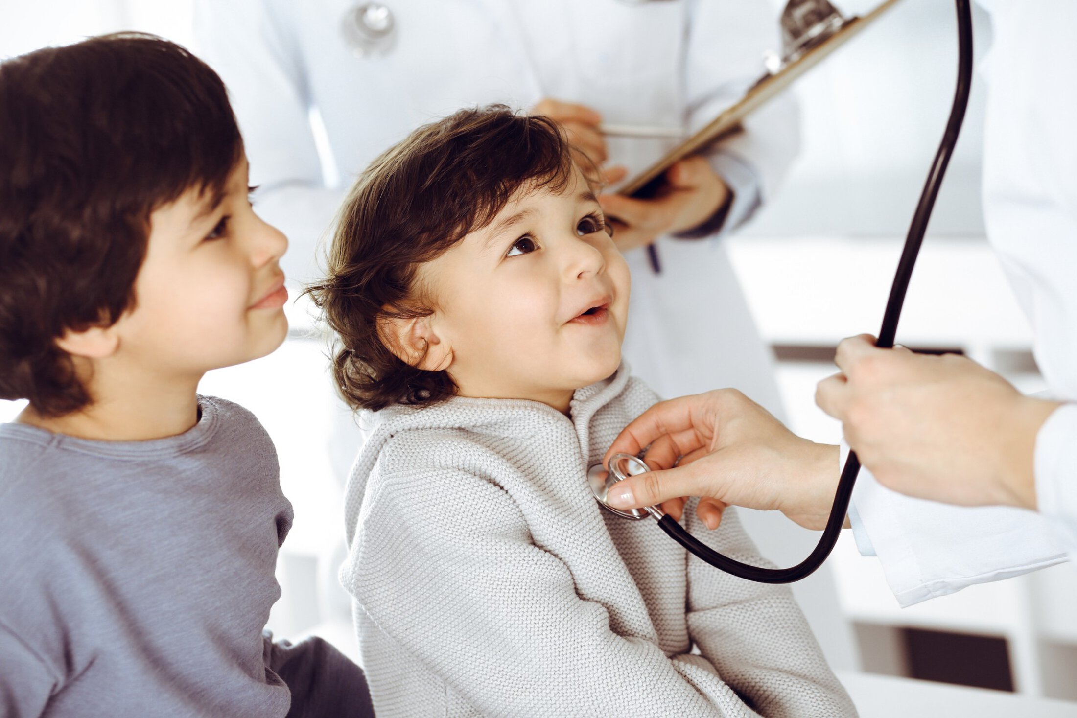 MUSC Health In Patient Rehab Woman-doctor examining a child patient by stethoscope. Cute arab toddler and his brother at physician appointment. Medicine concept