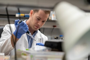 A researcher concentrates on his work in the lab.
