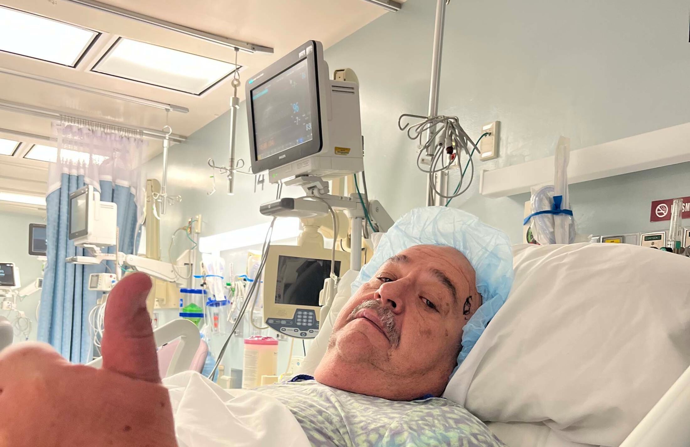 A man lying in a hospital bed gives a thumbs-up. He's state Rep. Bill Hager. He had Rocky Mountain spotted fever.
