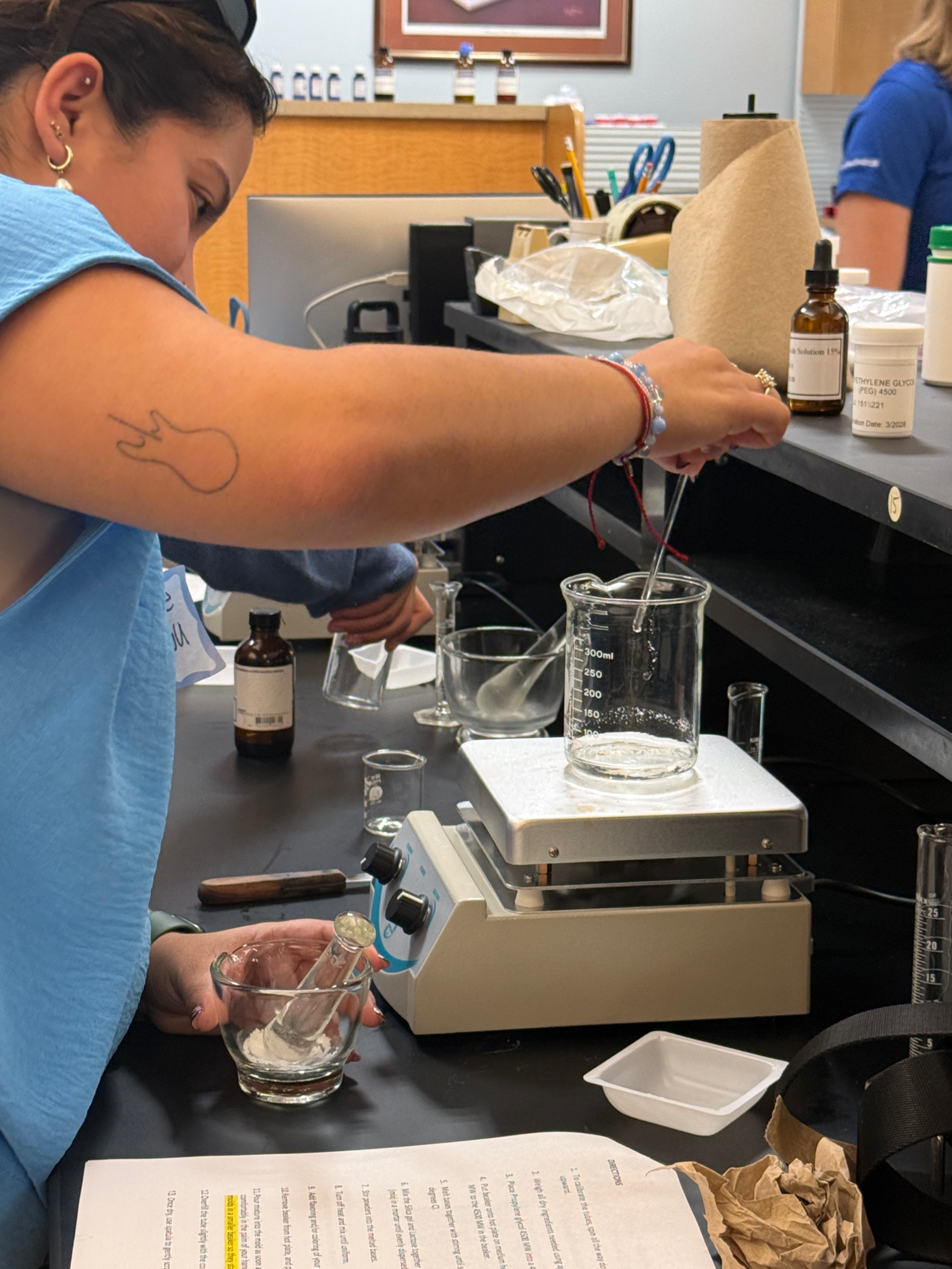 Prospective pharmacy student participating in compounding lab activity.
