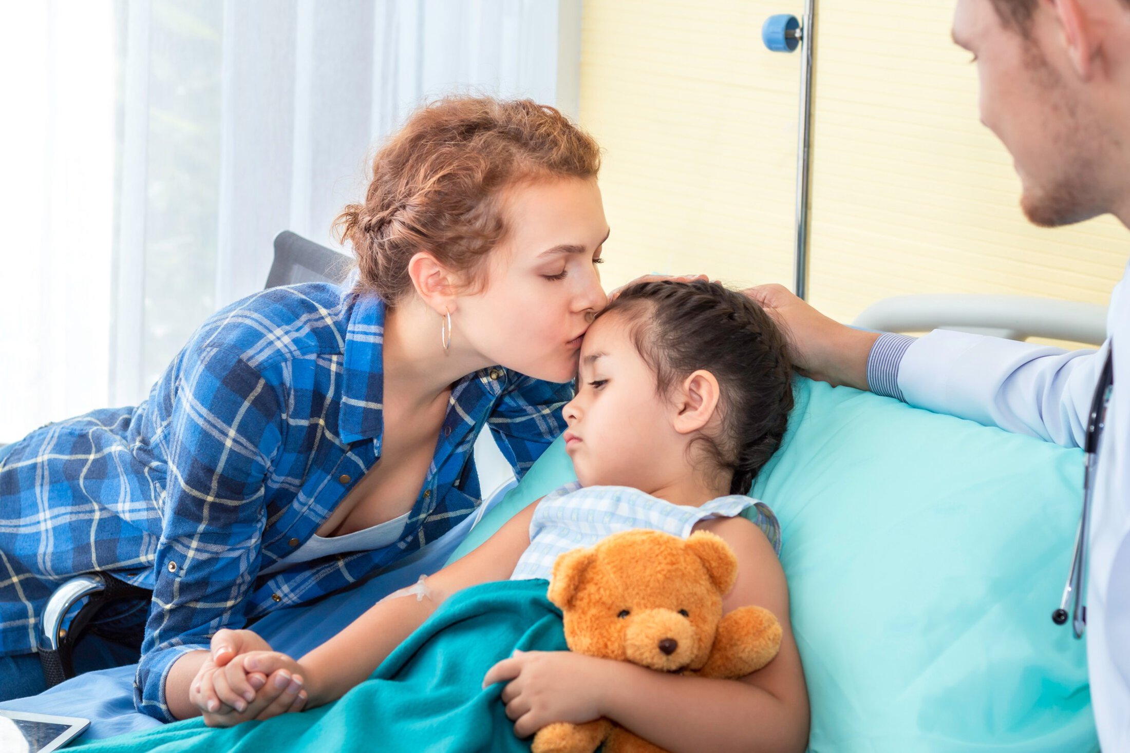 MUSC Health In Patient Rehab Mother kiss, reassuring and discussing her daughter. Patient girl sad on bedroom hospital.
