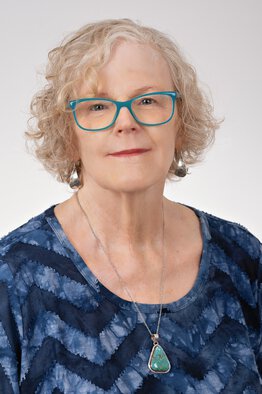 Karen Hartwell, MD wearing a blue shirt, a non white coat image