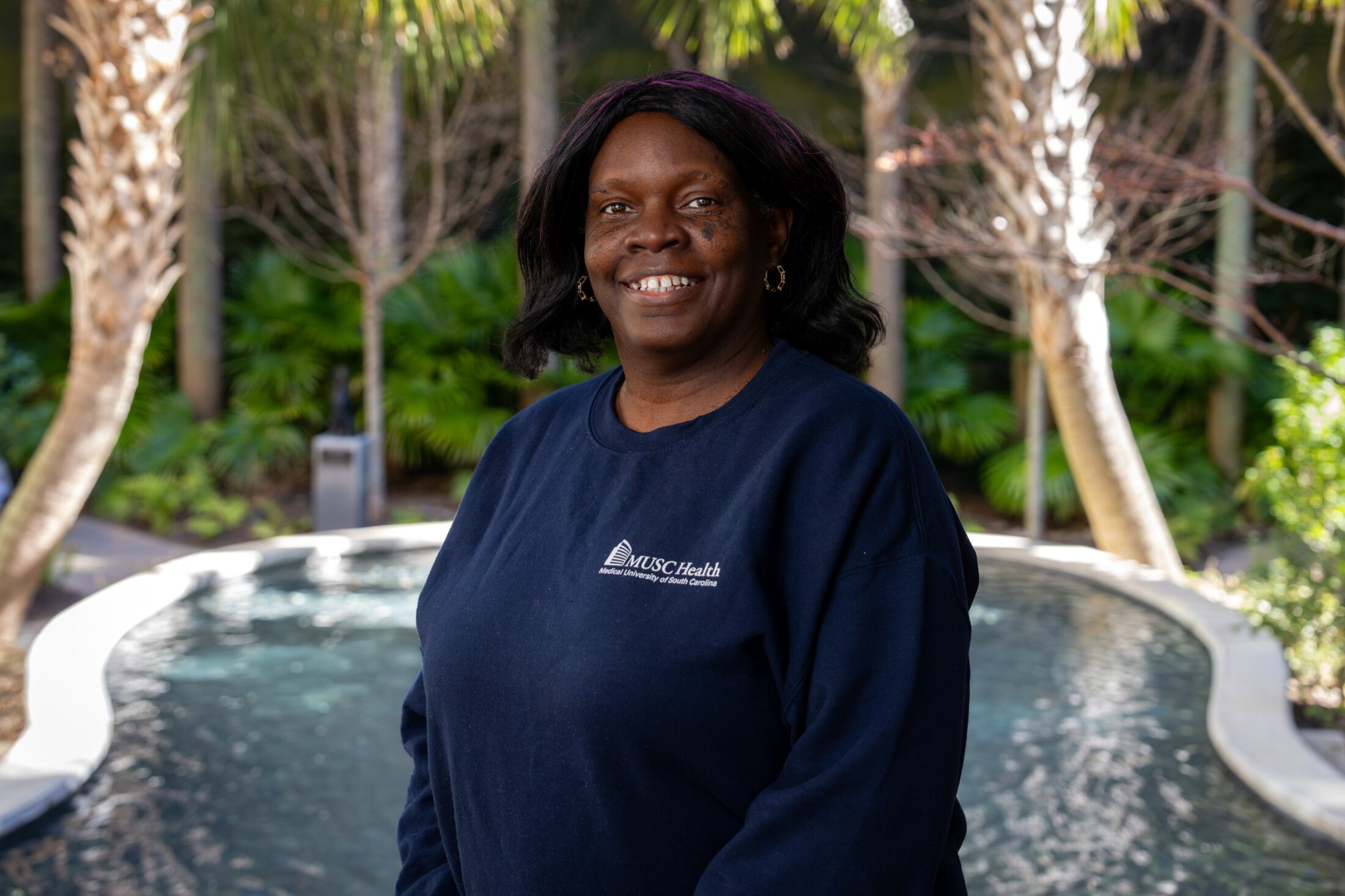 a woman poses six years after her colorectal cancer diagnosis and treatment