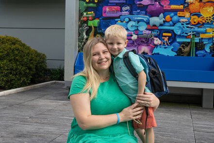 a mother and child smile happily