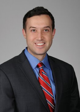 Scott Lindhorst, MD, Medical Oncology,Neuro-Oncology,Cancer - Brain & Spine Tumors wearing a suite with a red striped tie