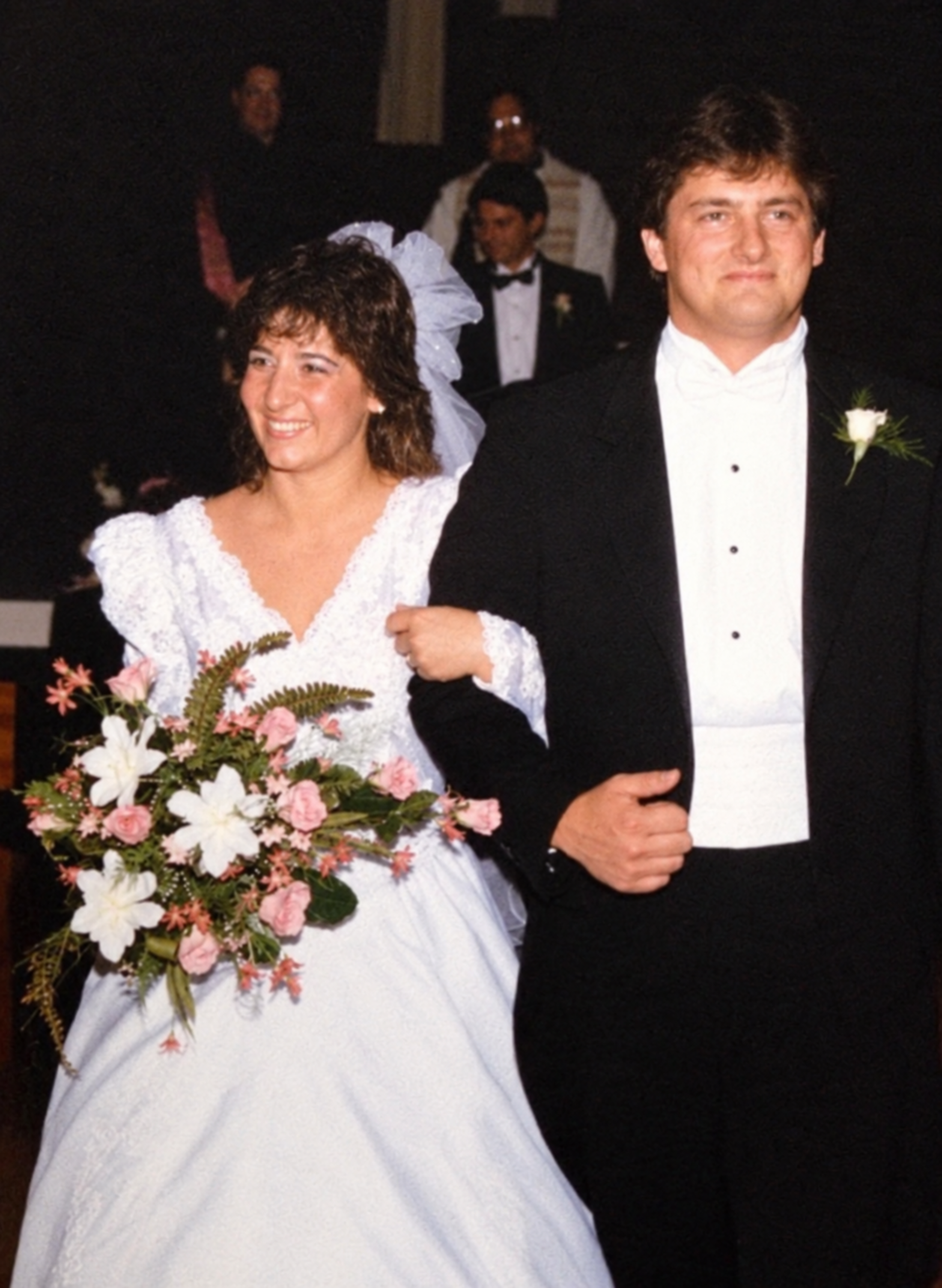 A 1980s era image of a bride and groom walking down the aisle from the altar.