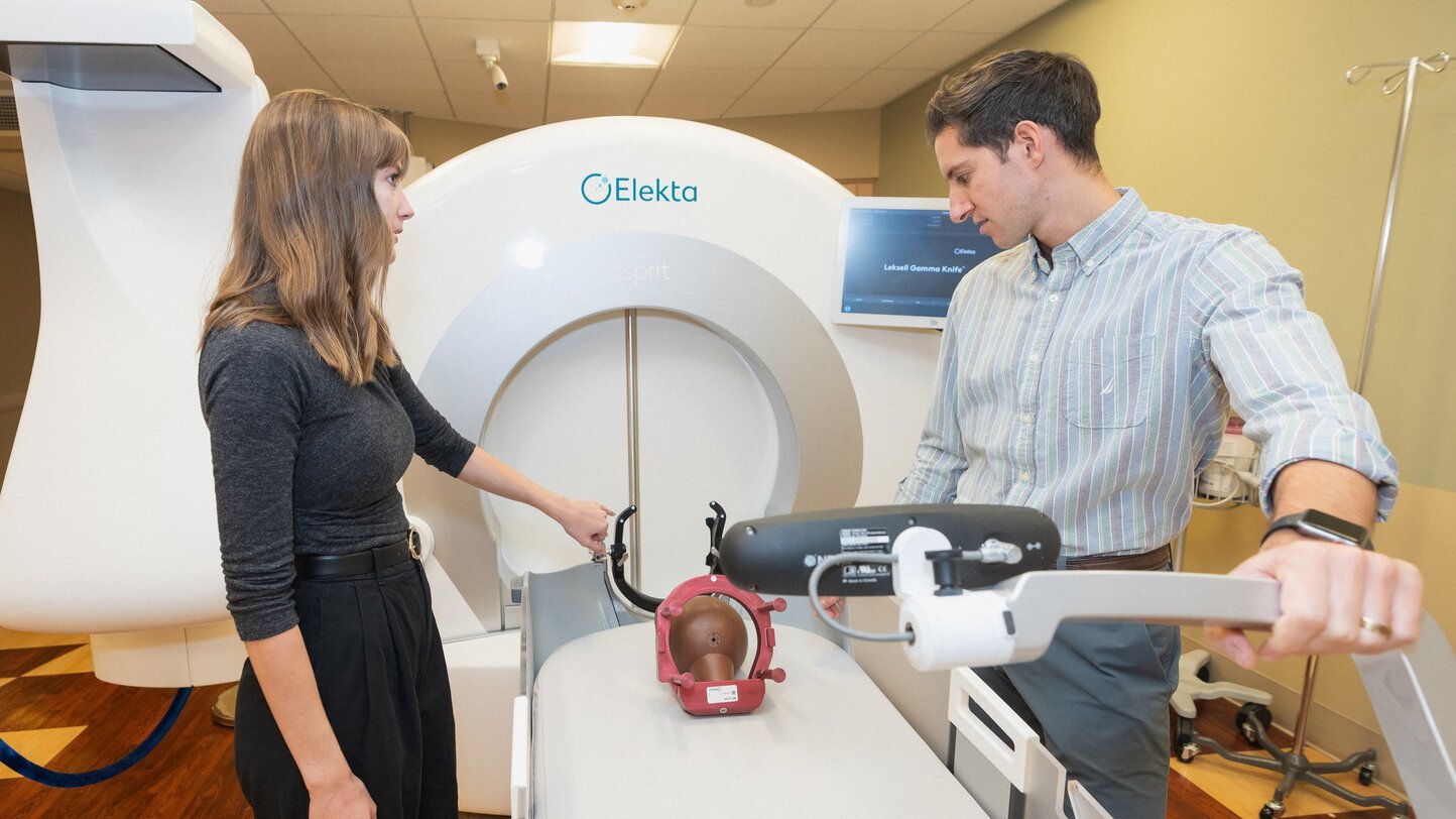 A senior resident shows a junior resident how to set up the Elekta Esprit gamma knife.