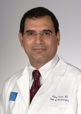 Abhay Varma, MBBS, MSCR, Neurosurgery, Cancer - Brain & Spine Tumors,Spine Surgery wearing a white coat