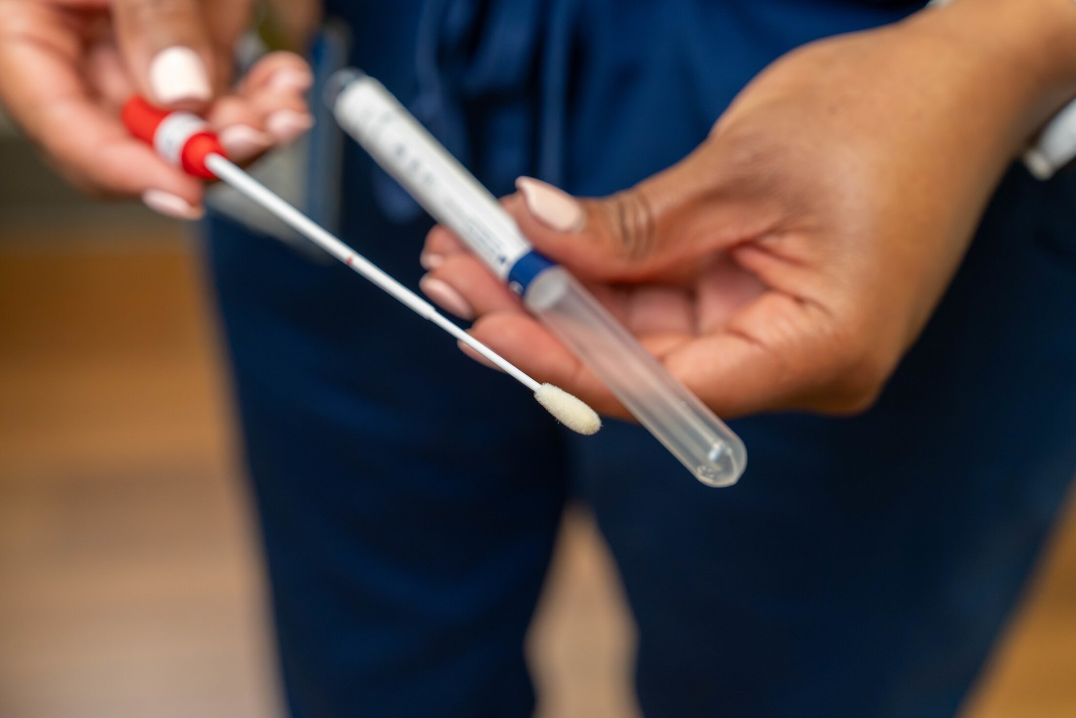 Closeup of a long swab used for self-collection during cervical cancer screening.