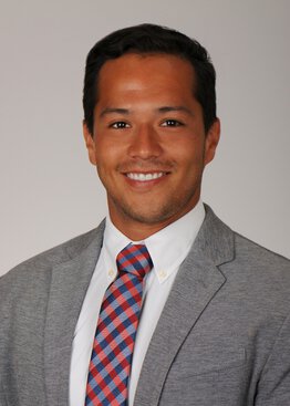 Brian Saway wearing a grey suite and tie