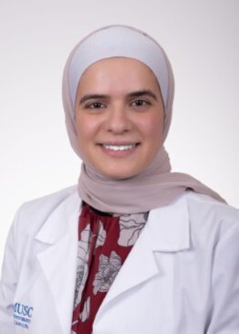 Core Faculty/Primary Care Duaa Alkhader MD wearing a white coat
