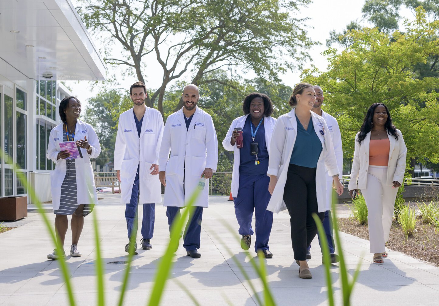 Faculty, residents and staff walking on campus.