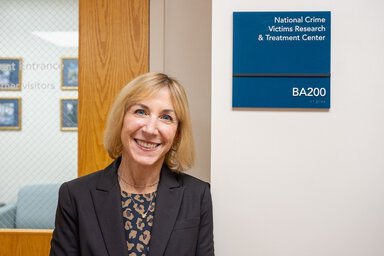 Rochelle Hanson, PhD Addressing Childhood Trauma standing in front of office