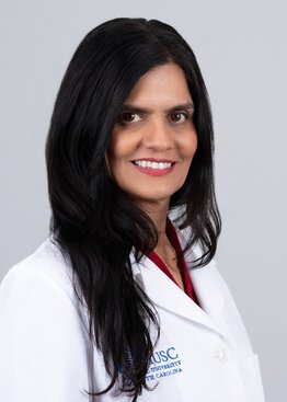 Gayathri Devi, Ph.D. Professor, College of Medicine Vice Chair of Innovation wearing a white coat