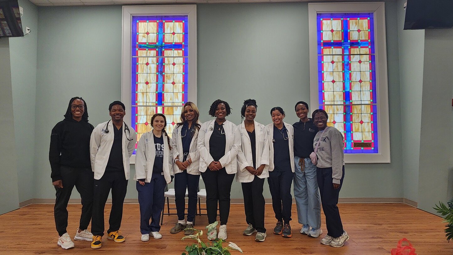 Multiple Students and residents volunteer at local church health fair